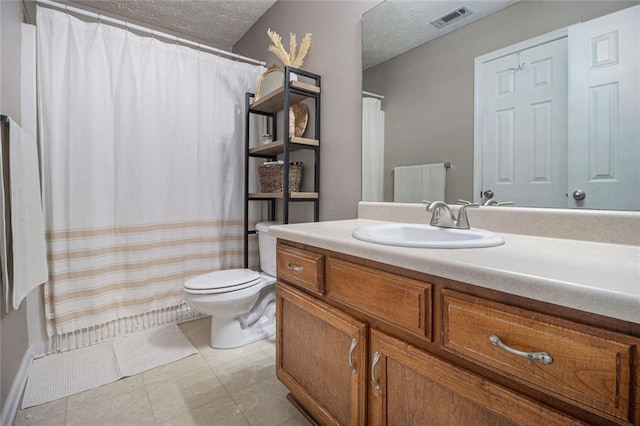 bathroom with vanity, tile patterned floors, a textured ceiling, and toilet