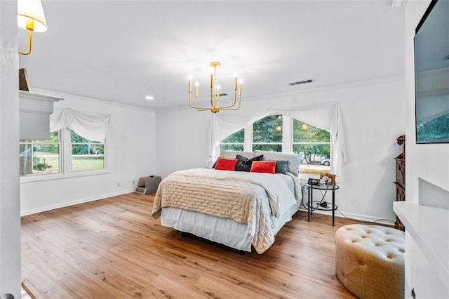 bedroom with multiple windows, an inviting chandelier, hardwood / wood-style flooring, and ornamental molding