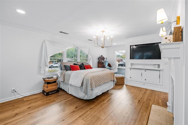 bedroom with hardwood / wood-style flooring, crown molding, and a notable chandelier