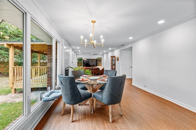 dining space with ornamental molding, plenty of natural light, and light hardwood / wood-style floors