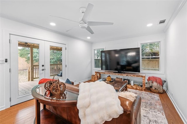 living room featuring ornamental molding, ceiling fan, french doors, and light hardwood / wood-style floors