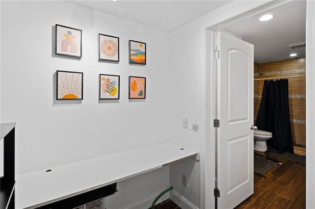 hallway featuring dark wood-style floors, an office area, and recessed lighting