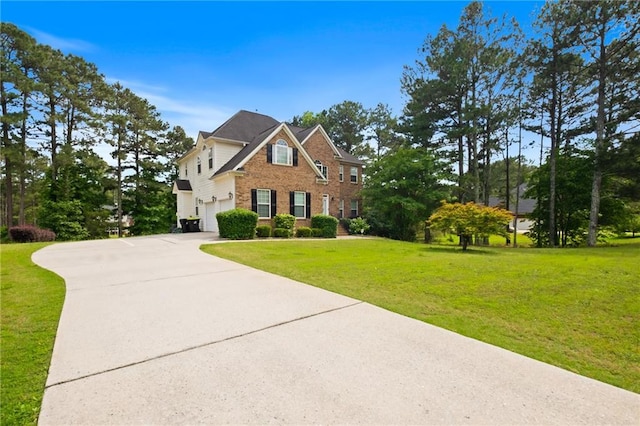 view of front of home with an attached garage, driveway, brick siding, and a front lawn
