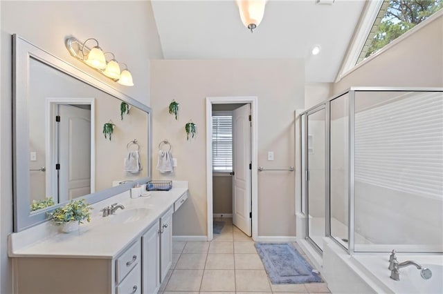 full bath with a stall shower, tile patterned floors, vanity, baseboards, and vaulted ceiling