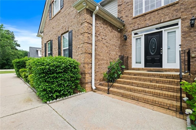 doorway to property with brick siding