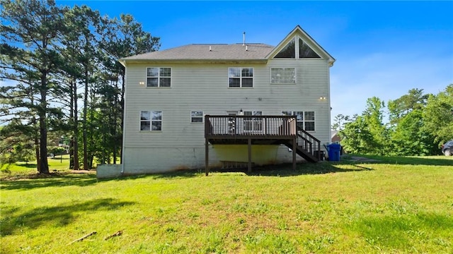 rear view of house featuring a wooden deck, stairway, and a lawn