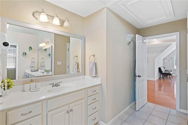 bathroom with tile patterned flooring, vanity, and baseboards