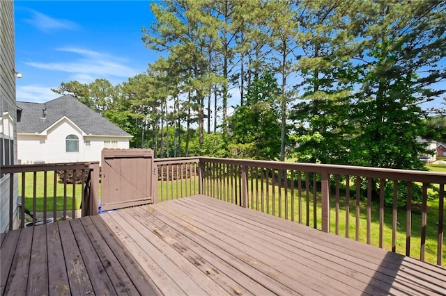 deck with a lawn, a storage unit, and an outdoor structure