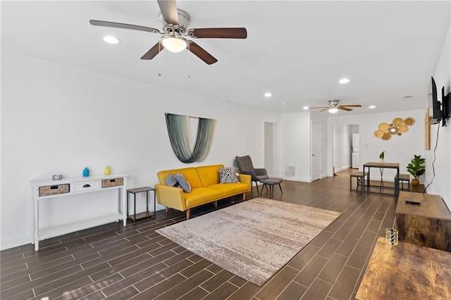 living area with a ceiling fan, wood finish floors, recessed lighting, and baseboards