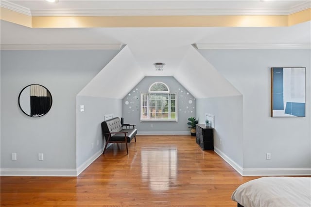 bedroom with wood finished floors, baseboards, and vaulted ceiling