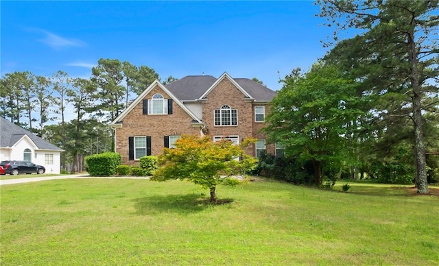 view of front of home with brick siding and a front yard