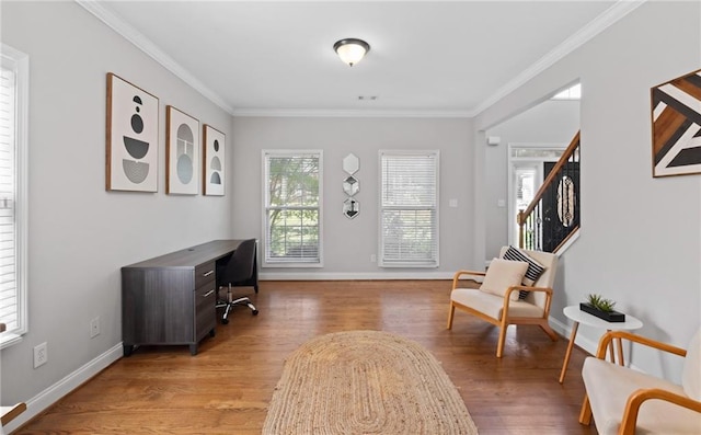 office area with crown molding, light wood-style flooring, and baseboards