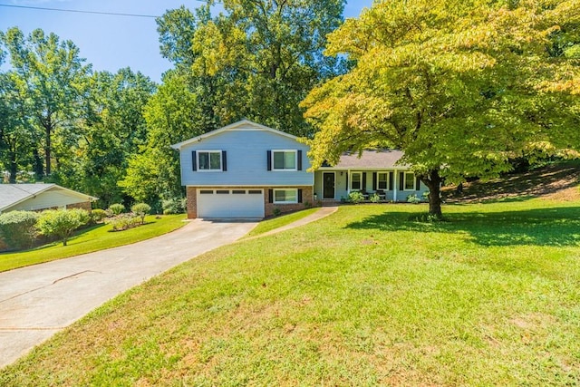 split level home with a garage and a front lawn