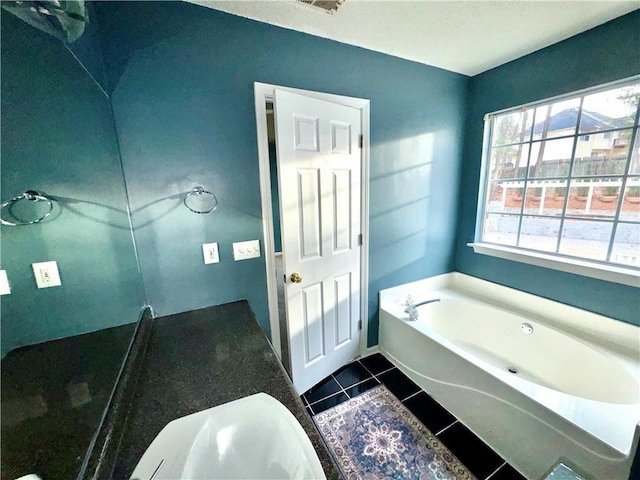 full bathroom with a sink, tile patterned flooring, and a bath