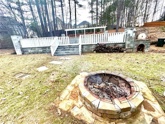 view of yard with an outdoor fire pit and a wooden deck