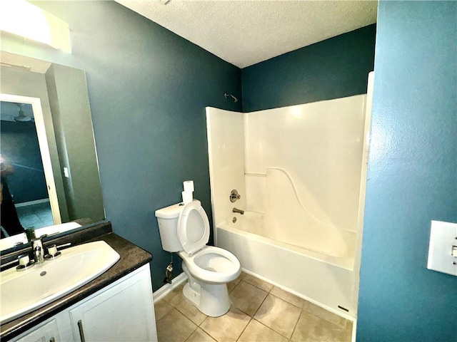 full bathroom featuring shower / washtub combination, toilet, vanity, a textured ceiling, and tile patterned floors