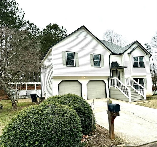 bi-level home featuring a garage and concrete driveway