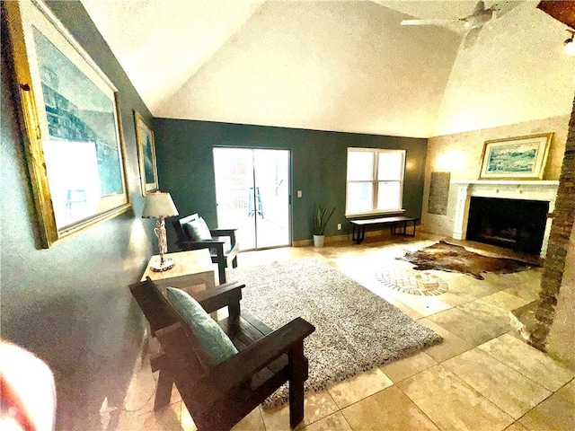 living area with lofted ceiling, a textured ceiling, and a fireplace