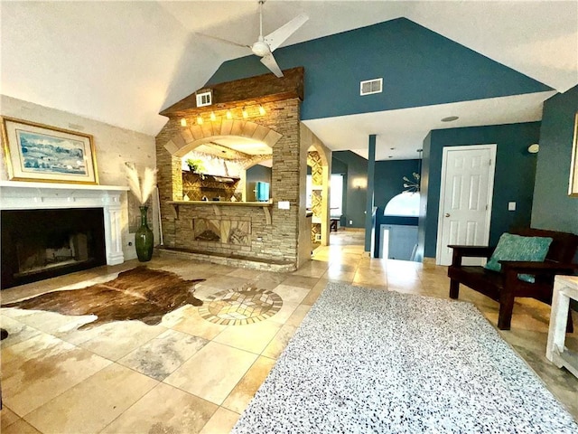 interior space featuring vaulted ceiling, visible vents, and a fireplace