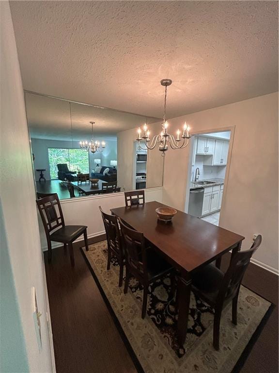 6851 Roswell Rd Unit O10, Atlanta, GA 30328 - dining space with a chandelier, a textured ceiling, and dark wood finished floors