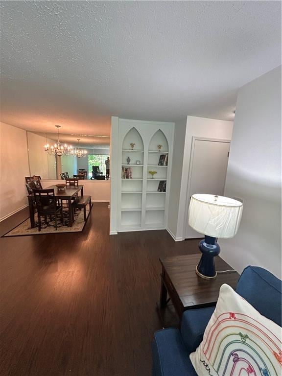 6851 Roswell Rd Unit O10, Atlanta, GA 30328 - living area with dark wood-type flooring, a chandelier, and a textured ceiling
