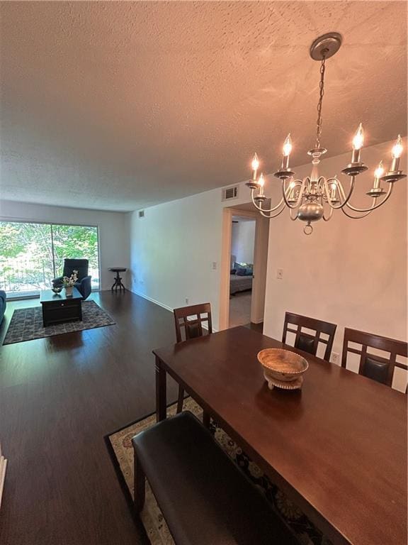 6851 Roswell Rd Unit O10, Atlanta, GA 30328 - dining space with a chandelier, a textured ceiling, and wood finished floors