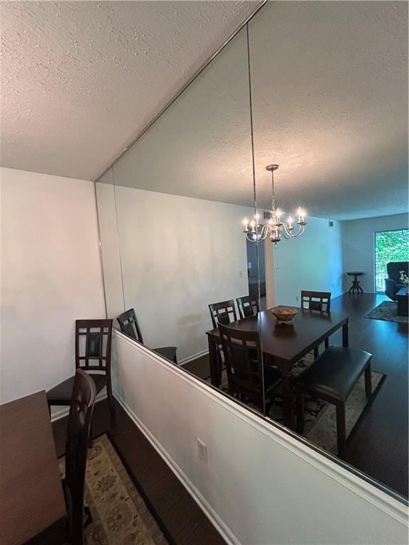 6851 Roswell Rd Unit O10, Atlanta, GA 30328 - dining area featuring a textured ceiling, a chandelier, and wood finished floors