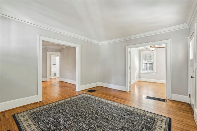 spare room with light hardwood / wood-style floors, ceiling fan, and ornamental molding