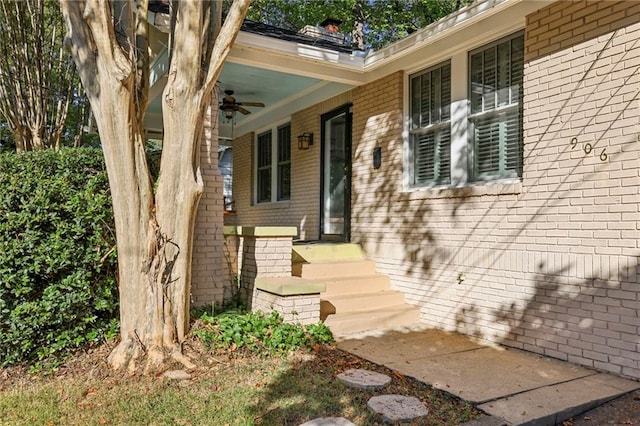 view of exterior entry featuring ceiling fan