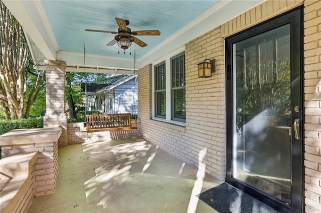 view of patio with ceiling fan and a porch