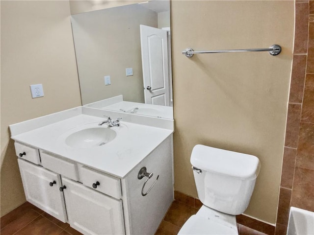 bathroom featuring toilet, tile patterned flooring, and vanity