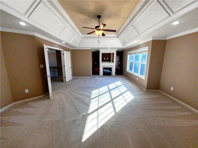 unfurnished living room with light colored carpet, ceiling fan, crown molding, and a tray ceiling