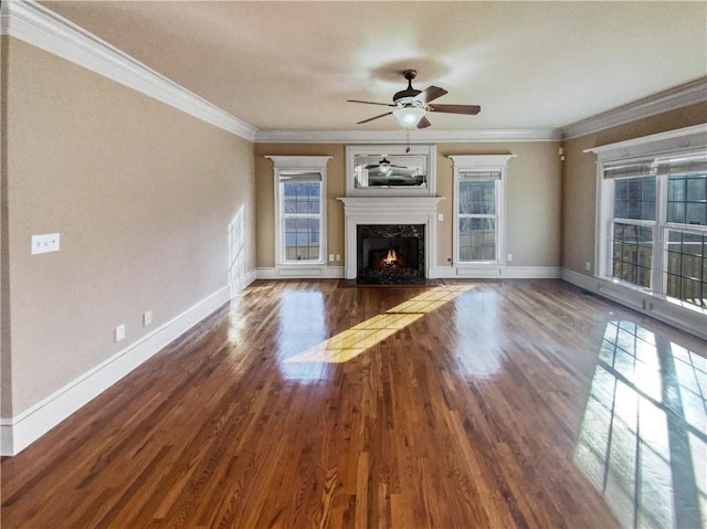 unfurnished living room featuring ornamental molding, a healthy amount of sunlight, and a high end fireplace