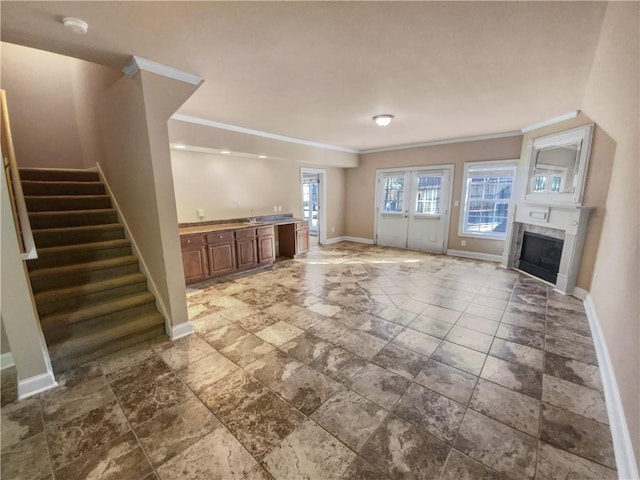 unfurnished living room with ornamental molding