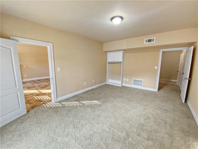 unfurnished bedroom featuring a closet and carpet flooring