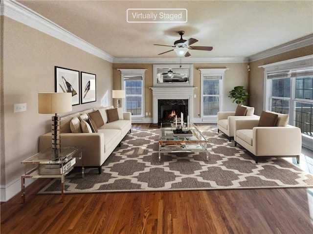 living room featuring a high end fireplace, ceiling fan, hardwood / wood-style flooring, and crown molding