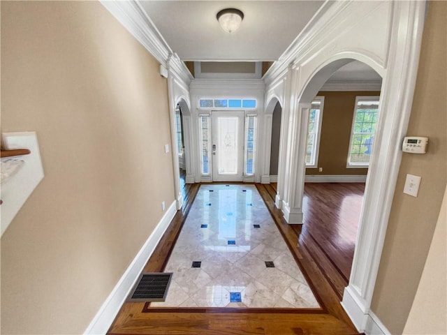 entryway featuring crown molding