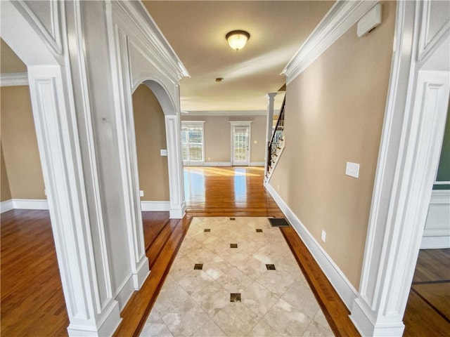 hallway featuring crown molding and light hardwood / wood-style flooring