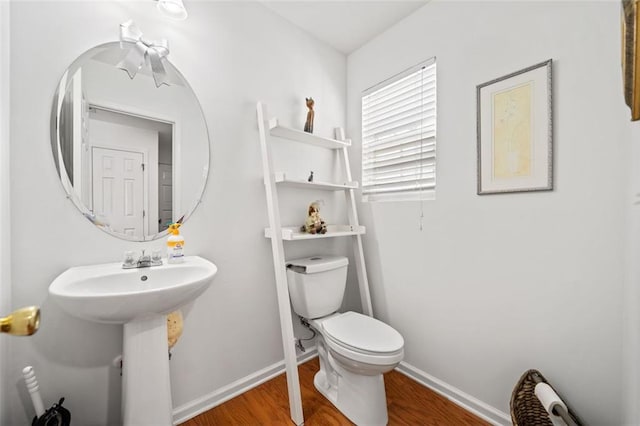 bathroom featuring hardwood / wood-style floors and toilet