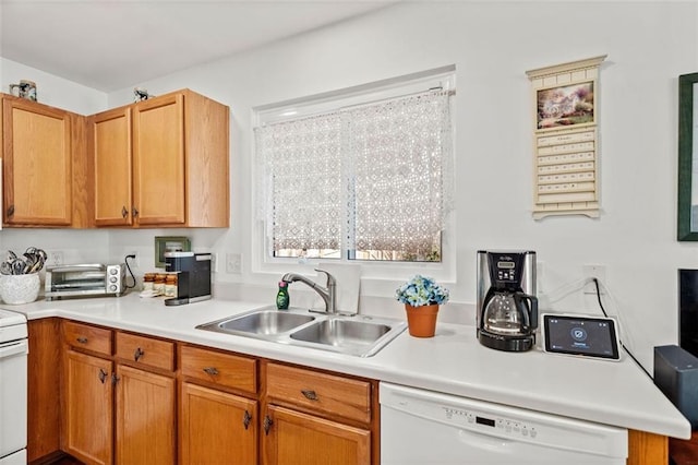 kitchen featuring white appliances and sink