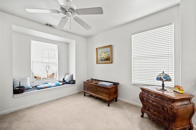 sitting room featuring light colored carpet and ceiling fan