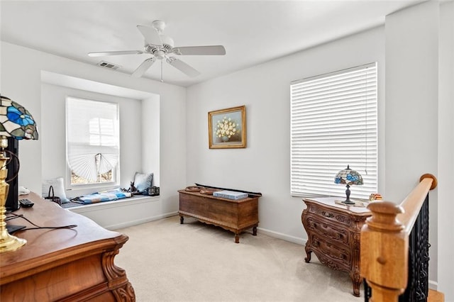 sitting room featuring light carpet and ceiling fan