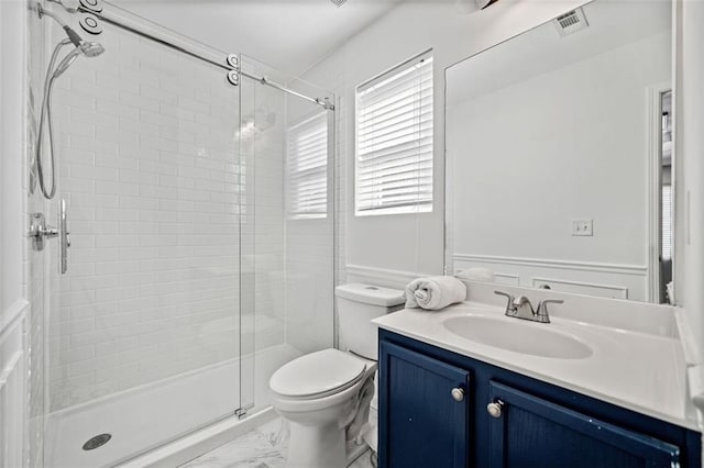 bathroom with vanity, toilet, and walk in shower