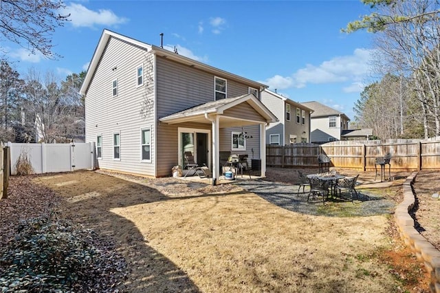 back of property featuring a lawn and a patio area