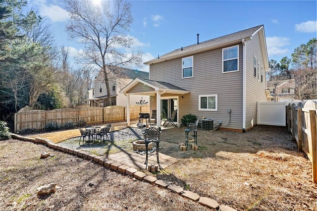 rear view of property featuring central AC unit and a patio