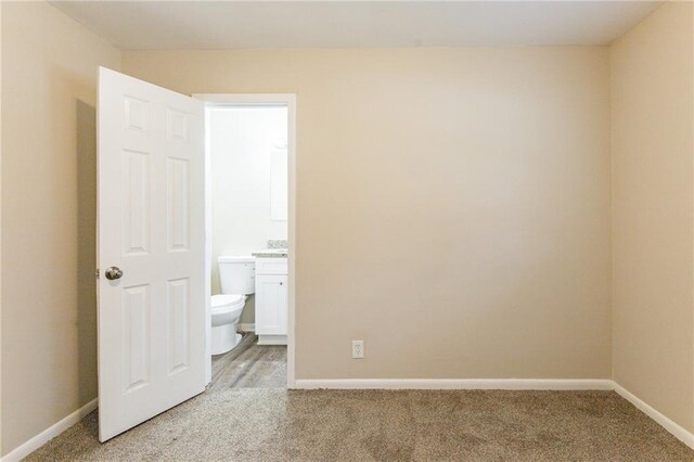453 Utoy Cir SW, Atlanta, GA 30331 - unfurnished bedroom featuring ensuite bathroom and carpet