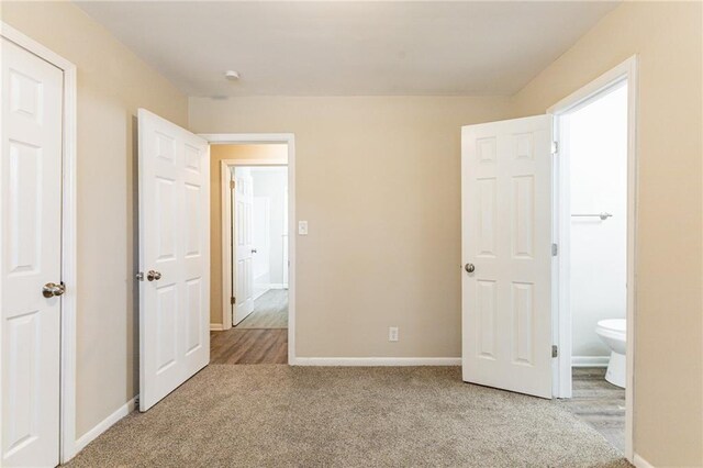 453 Utoy Cir SW, Atlanta, GA 30331 - unfurnished bedroom with light colored carpet and connected bathroom