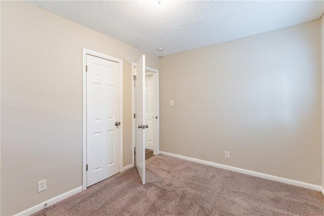 453 Utoy Cir SW, Atlanta, GA 30331 - unfurnished bedroom with carpet flooring and a textured ceiling