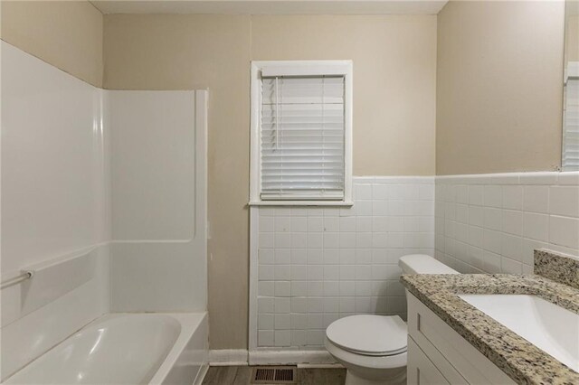 453 Utoy Cir SW, Atlanta, GA 30331 - bathroom featuring vanity, wood-type flooring, tile walls, and toilet