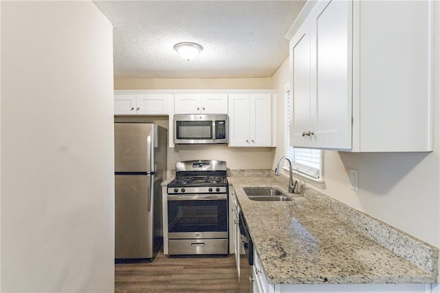 453 Utoy Cir SW, Atlanta, GA 30331 - kitchen featuring light stone counters, stainless steel appliances, dark wood-type flooring, sink, and white cabinets